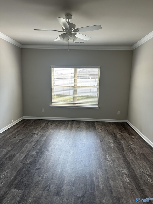 empty room with baseboards, visible vents, a ceiling fan, dark wood-style floors, and ornamental molding