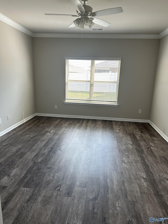 spare room featuring dark wood-type flooring, crown molding, baseboards, and ceiling fan