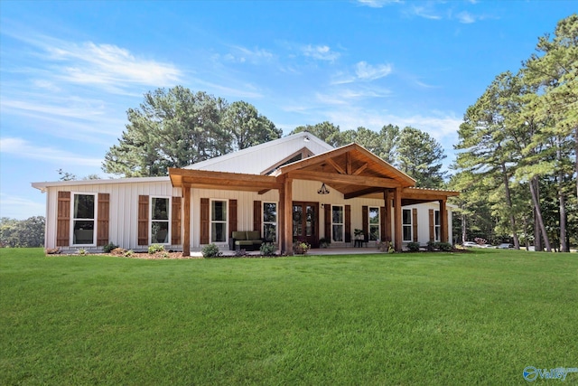 rear view of property with a yard