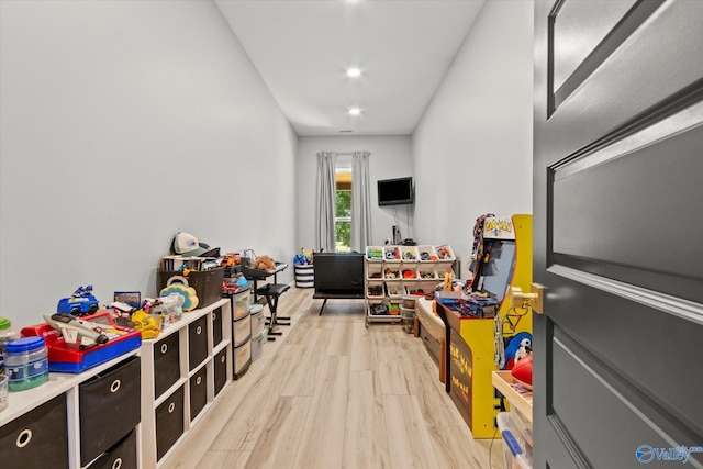 game room with light wood-type flooring