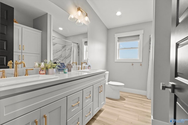 bathroom featuring vanity, a shower with curtain, wood-type flooring, and toilet