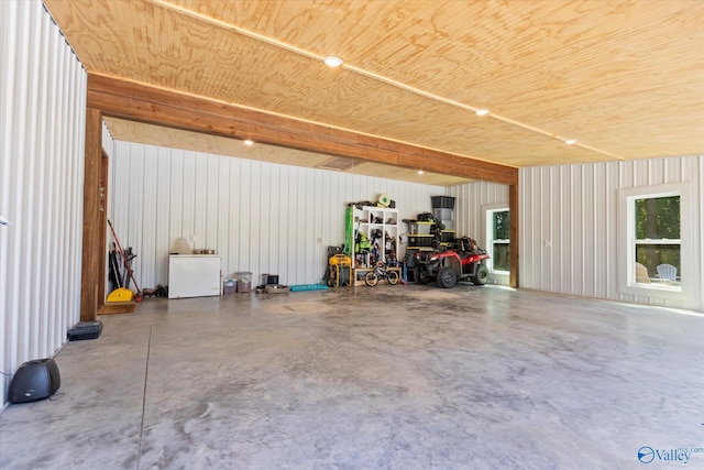 garage featuring refrigerator and wooden ceiling