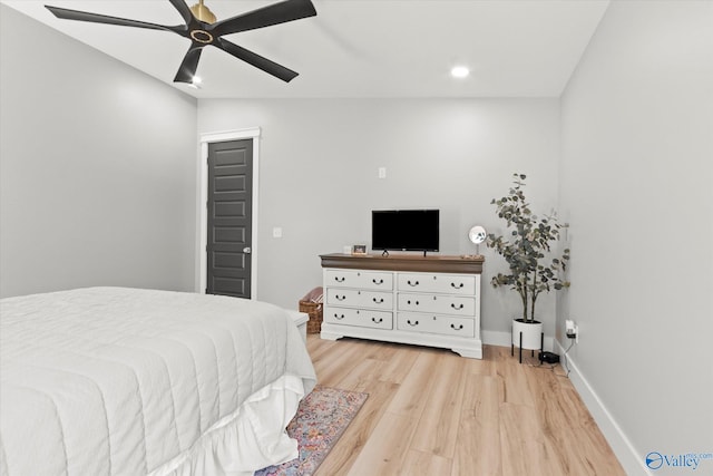 bedroom with light hardwood / wood-style flooring and ceiling fan