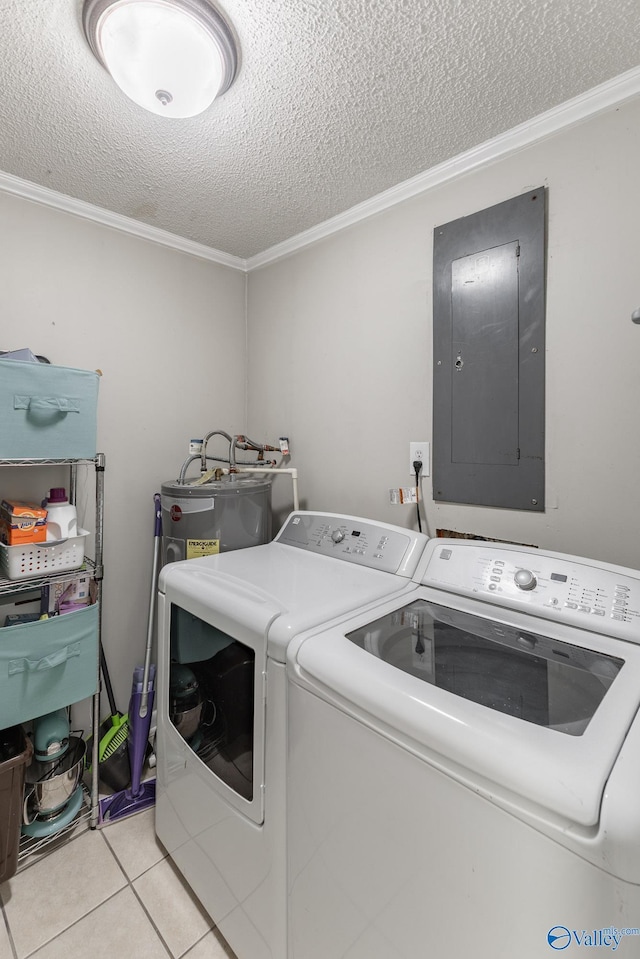 laundry area with light tile patterned floors, a textured ceiling, washing machine and dryer, laundry area, and electric panel