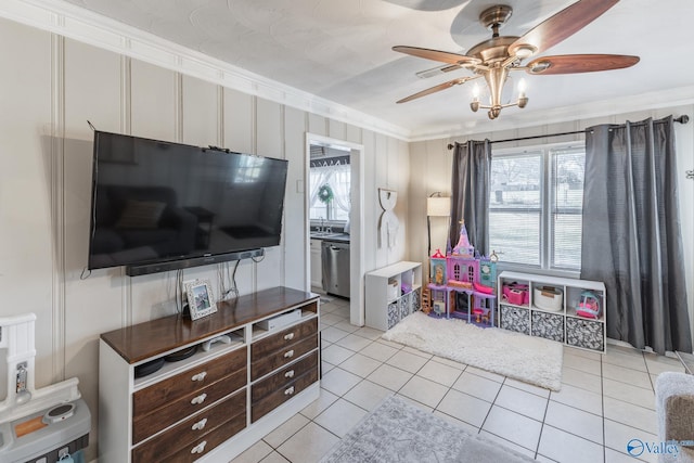 game room featuring ceiling fan, ornamental molding, a sink, and light tile patterned flooring