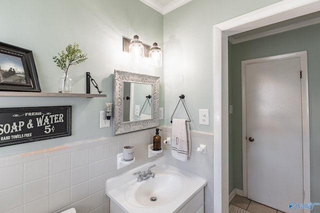 bathroom with ornamental molding, vanity, and tile walls