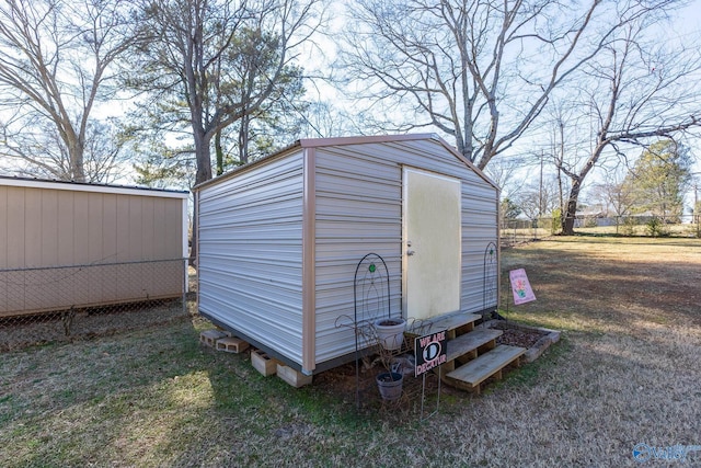 view of shed featuring fence