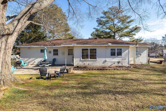 back of house featuring a patio area and a lawn