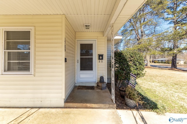 property entrance with a yard