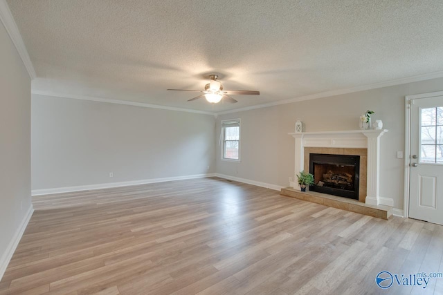 unfurnished living room featuring crown molding, light hardwood / wood-style floors, and a tile fireplace