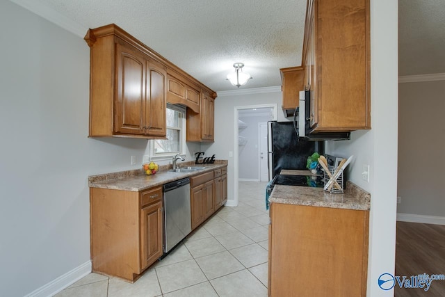 kitchen with crown molding, stainless steel appliances, sink, and a textured ceiling