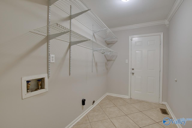 washroom featuring ornamental molding, washer hookup, and light tile patterned floors