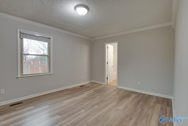 unfurnished room with ornamental molding, a textured ceiling, and light hardwood / wood-style floors