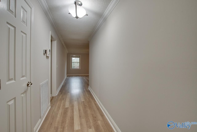 hall with crown molding, a textured ceiling, and light hardwood / wood-style flooring