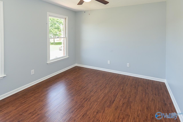 empty room featuring dark wood-type flooring and ceiling fan