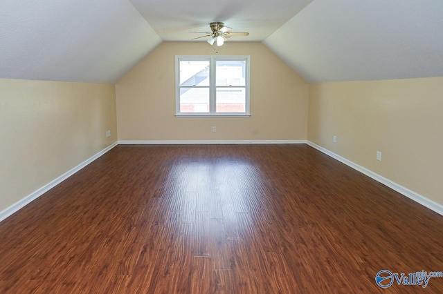 bonus room featuring vaulted ceiling, dark hardwood / wood-style floors, and ceiling fan