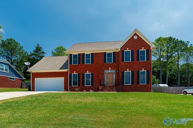 colonial house with a garage and a front lawn