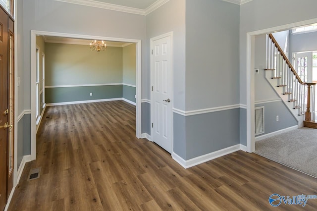 hall featuring crown molding, dark wood-type flooring, and a chandelier