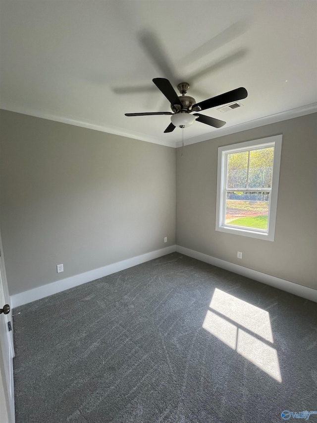 carpeted spare room with ceiling fan and ornamental molding