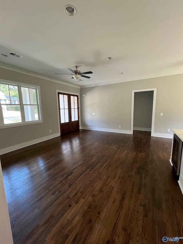 unfurnished living room with ceiling fan, ornamental molding, dark hardwood / wood-style flooring, and french doors