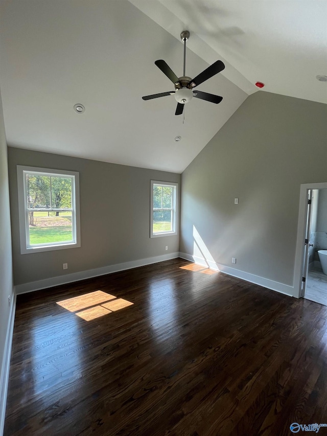 spare room featuring ceiling fan, dark hardwood / wood-style floors, and vaulted ceiling