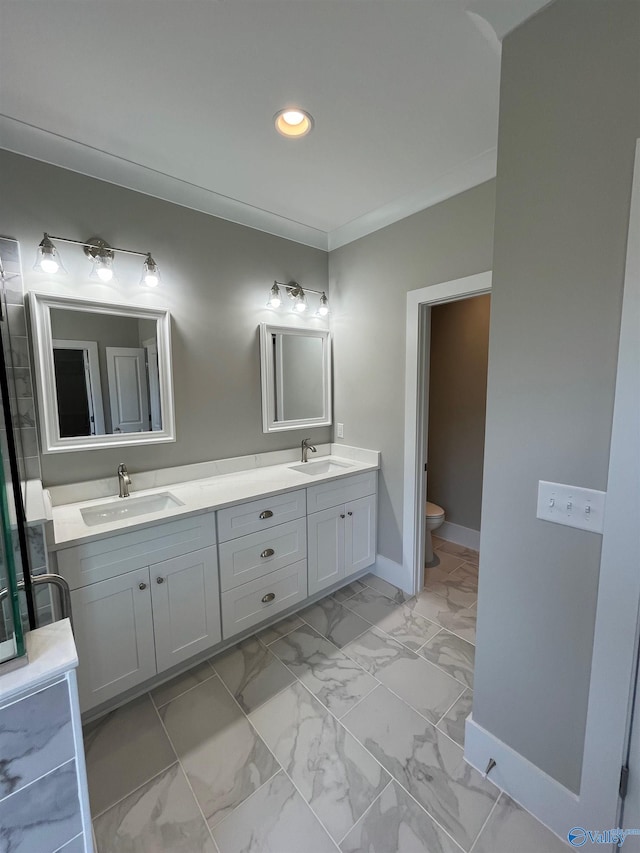 bathroom featuring toilet, crown molding, and vanity