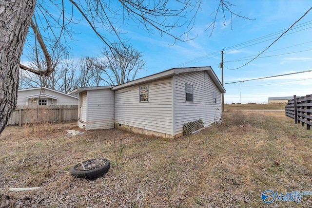 view of home's exterior with a fire pit