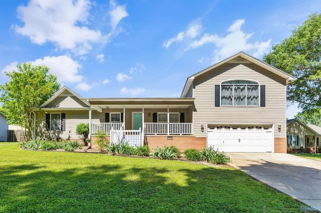 525 10th St, Arab, AL 35016 - tri-level home with covered porch, a front yard, a garage, and brick siding