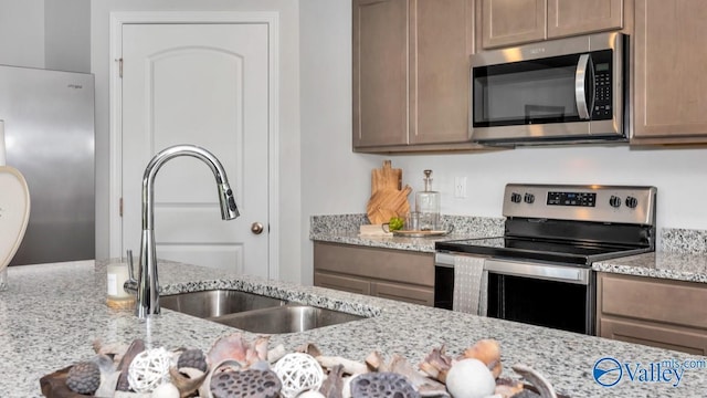 18882 Wicklow Cir, Athens, AL 35613 - kitchen featuring stainless steel appliances, a sink, and light stone counters