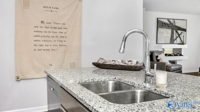 18882 Wicklow Cir, Athens, AL 35613 - kitchen with a sink, light stone counters, baseboards, and stainless steel dishwasher