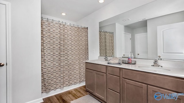 18882 Wicklow Cir, Athens, AL 35613 - bathroom featuring double vanity, wood finished floors, recessed lighting, and curtained shower