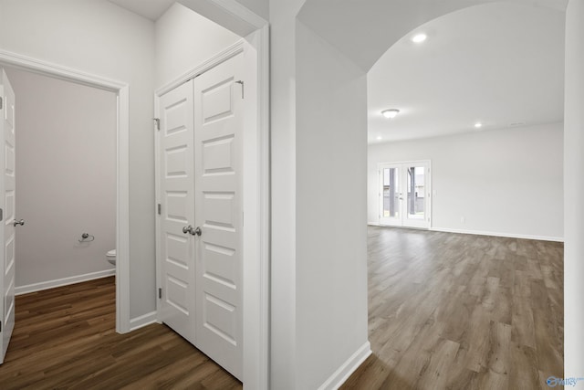 corridor with hardwood / wood-style flooring