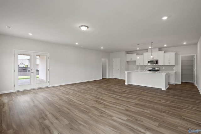 unfurnished living room featuring french doors and hardwood / wood-style floors