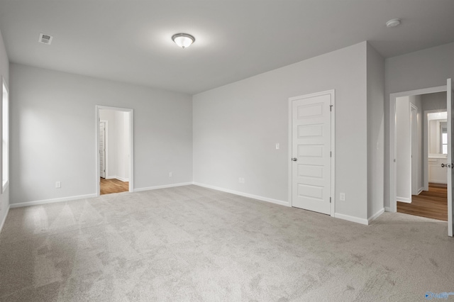 spare room with light colored carpet