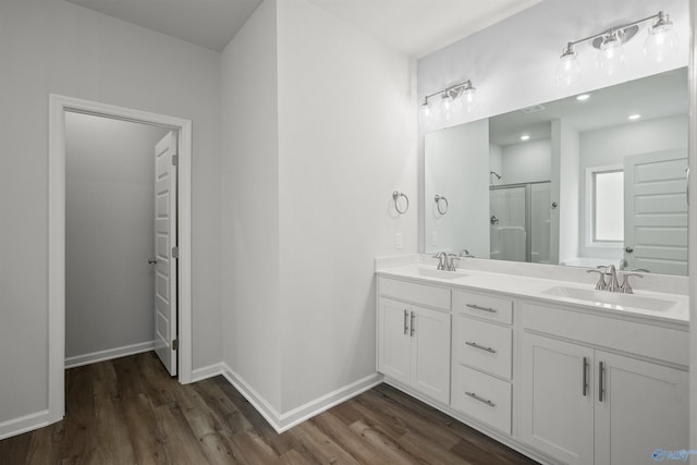 bathroom featuring hardwood / wood-style floors, vanity, and walk in shower