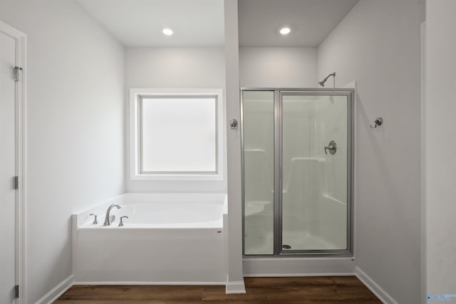 bathroom featuring hardwood / wood-style flooring and separate shower and tub