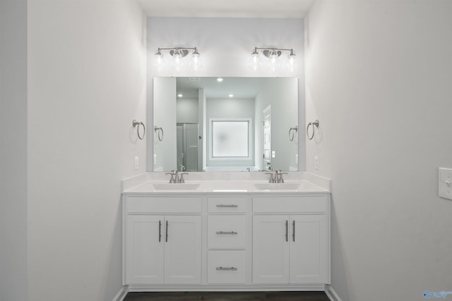 bathroom featuring vanity and an enclosed shower