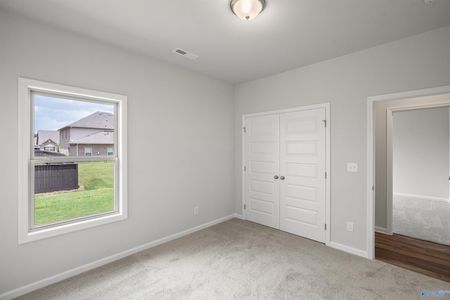 unfurnished bedroom with carpet floors and a closet