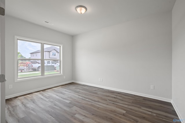 empty room with hardwood / wood-style flooring