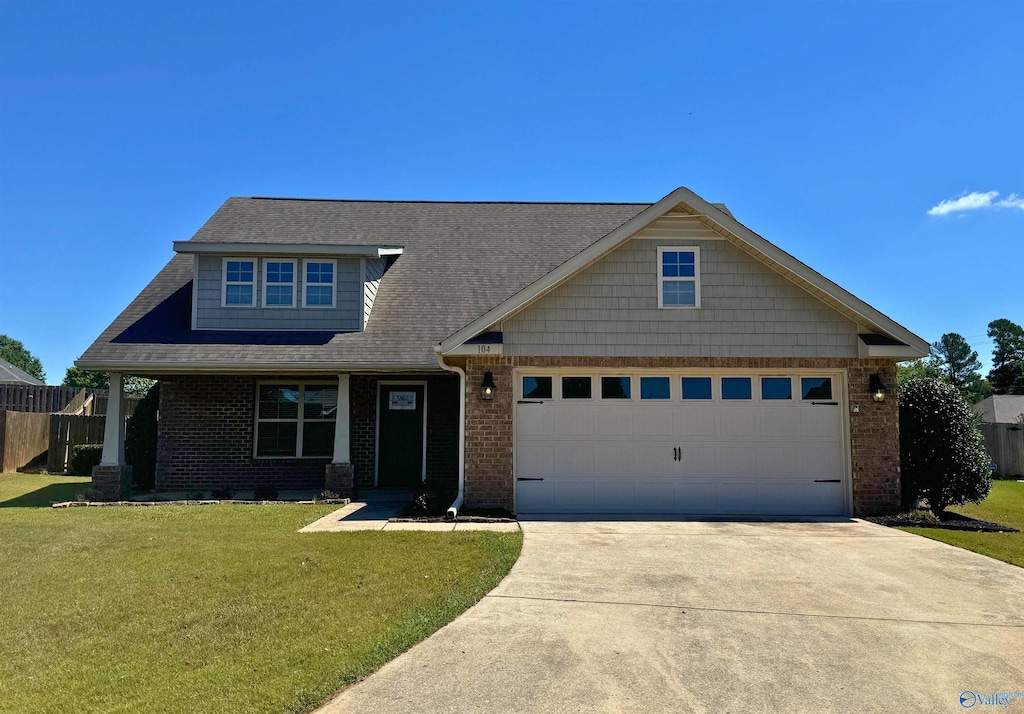 view of front of home featuring a garage and a front lawn