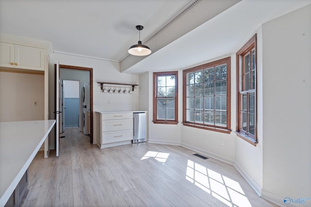 kitchen featuring white cabinetry, pendant lighting, white fridge, and light wood-type flooring