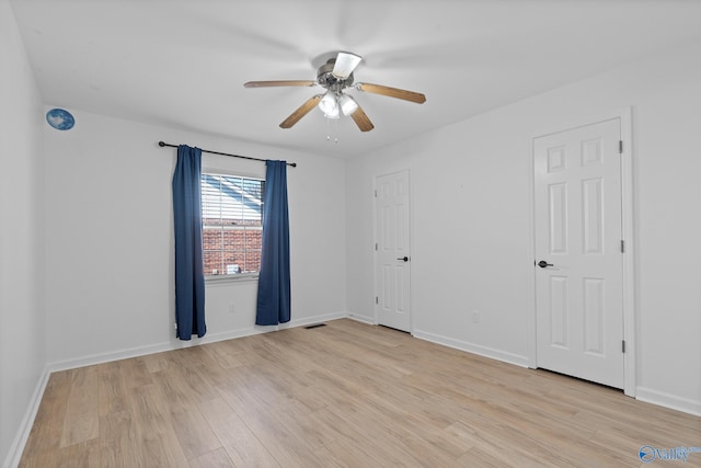 spare room with light hardwood / wood-style flooring and ceiling fan