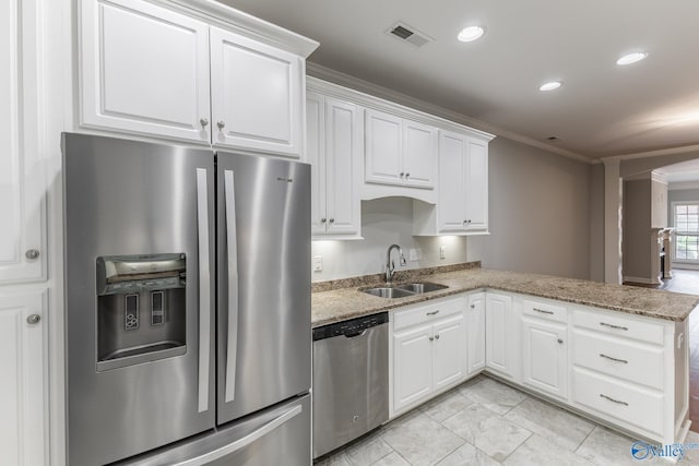 kitchen with crown molding, a sink, stainless steel appliances, white cabinetry, and visible vents