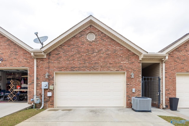garage featuring central AC and driveway