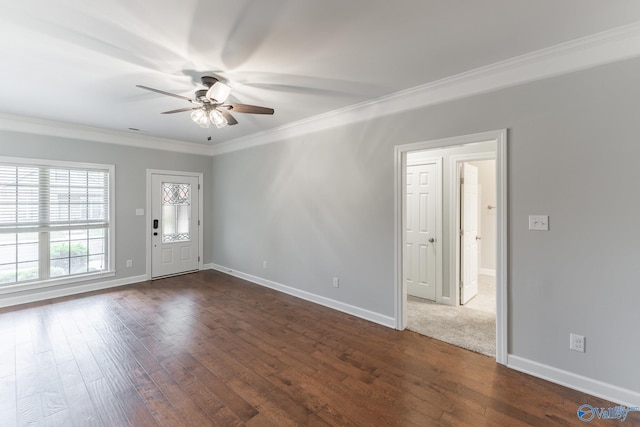 interior space featuring crown molding, a ceiling fan, dark wood-style flooring, and baseboards