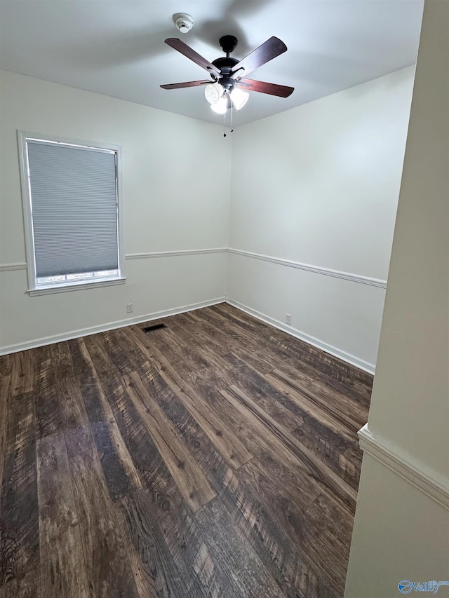 unfurnished room with dark hardwood / wood-style flooring and ceiling fan