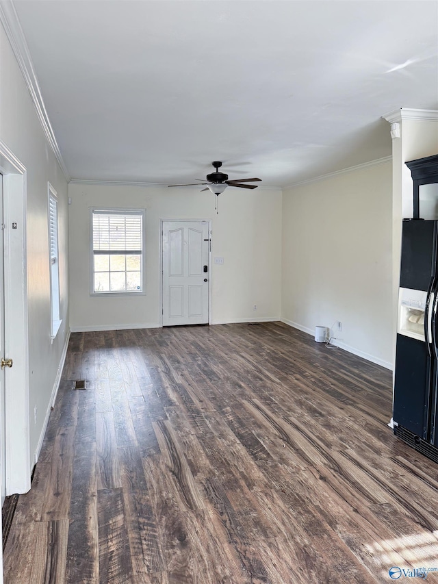 unfurnished living room featuring crown molding, ceiling fan, and dark wood-type flooring