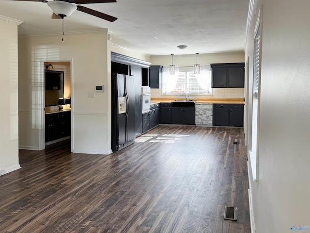 kitchen featuring black refrigerator with ice dispenser, wooden counters, dark wood-type flooring, and decorative light fixtures