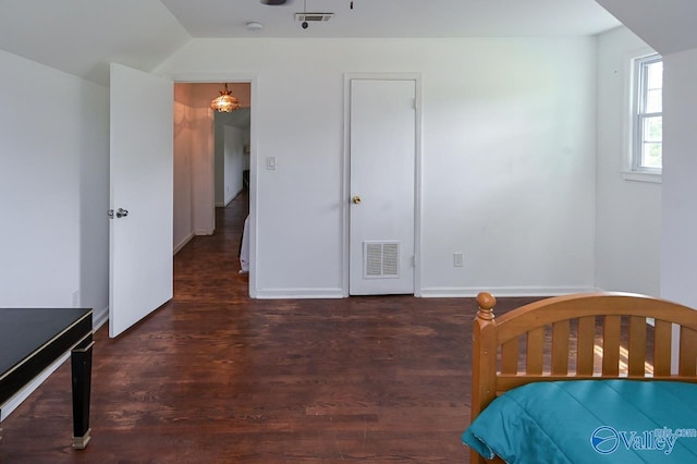 bedroom featuring dark wood-type flooring