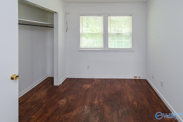 unfurnished bedroom featuring a closet and hardwood / wood-style floors